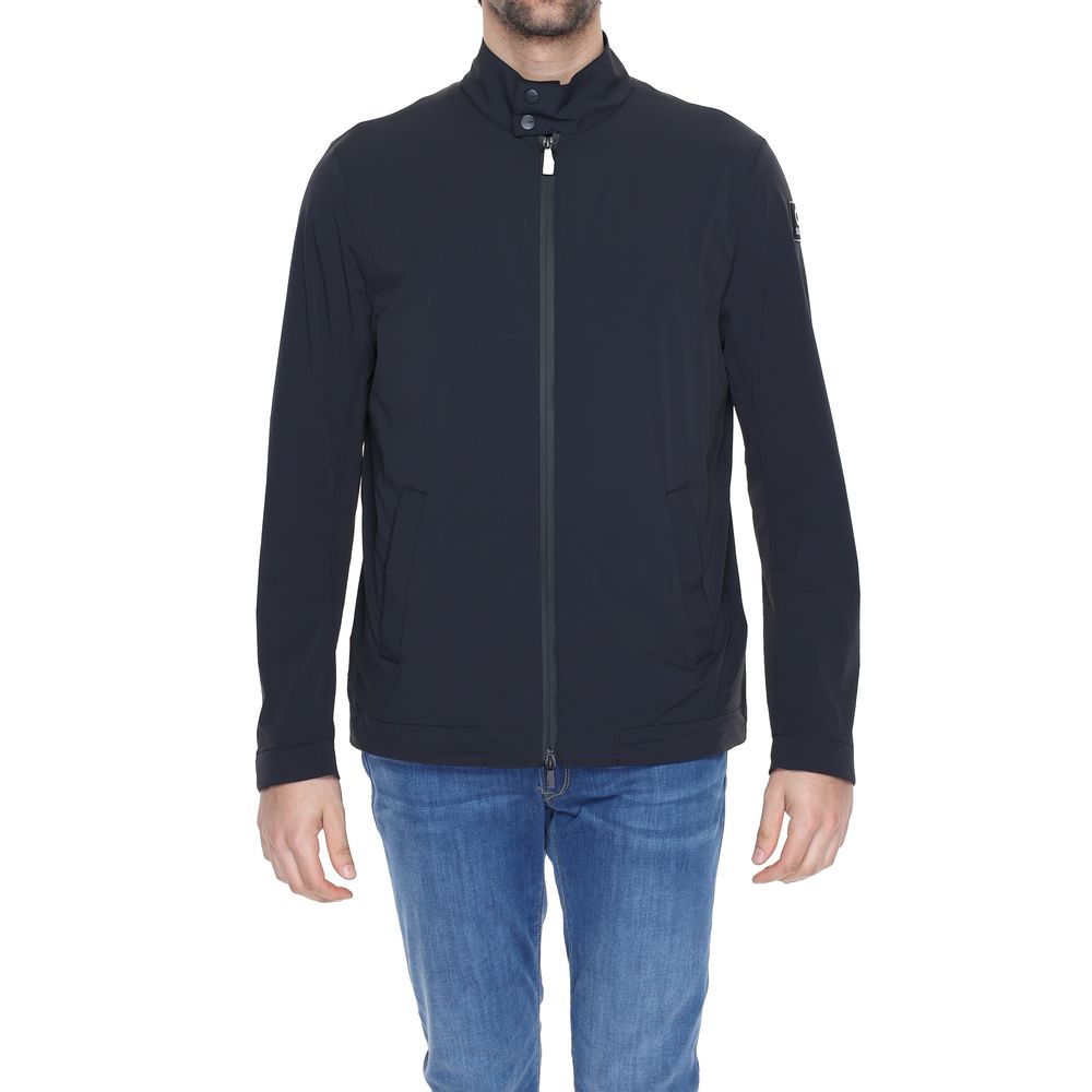 Person wearing a black jacket and blue jeans on a white background