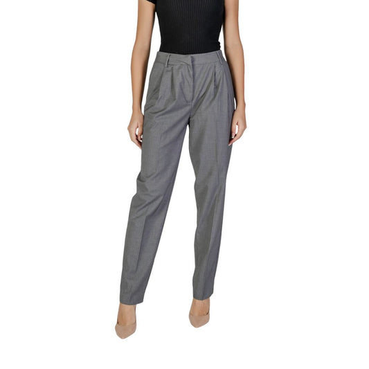 Gray pants worn by a person on a white background