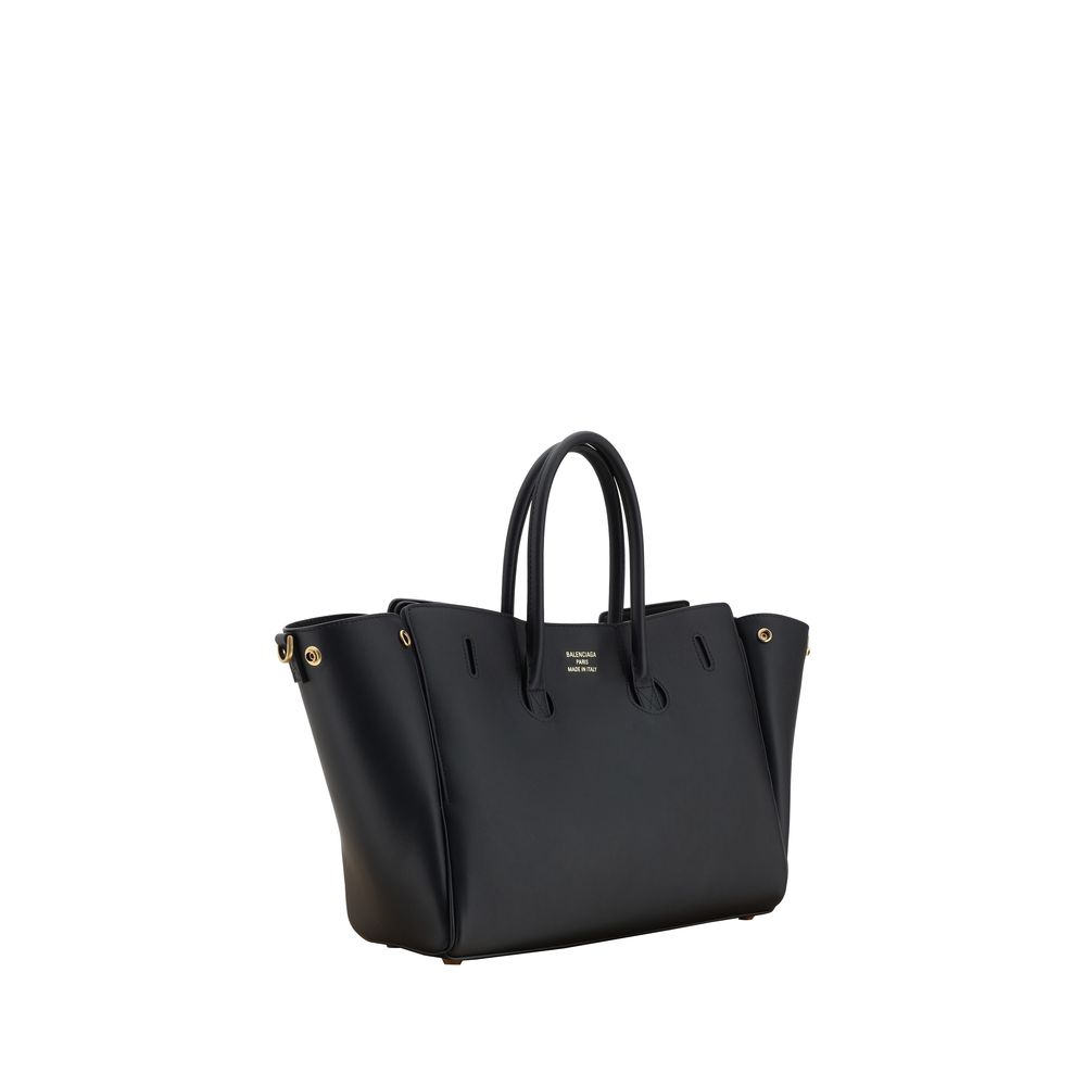 Black handbag with gold accents on a white background